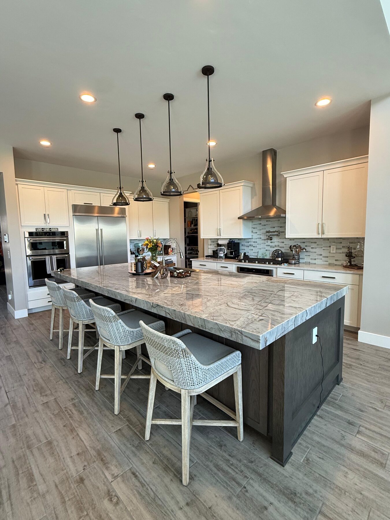 Luxury Las Vegas kitchen remodel with large island and black pendant lighting