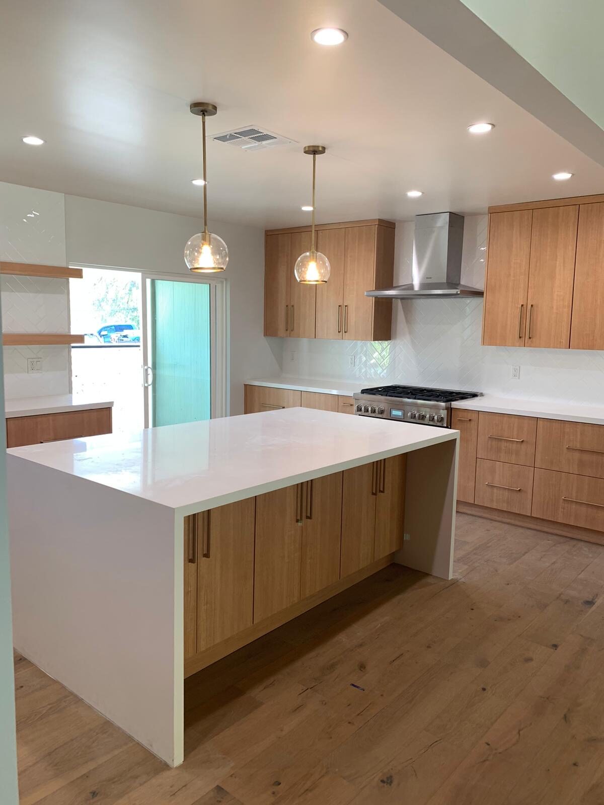 Mid-century modern kitchen renovation with globe pendant lighting