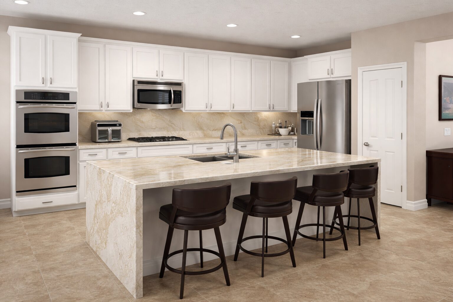 White kitchen renovation with waterfall island and dark bar stools